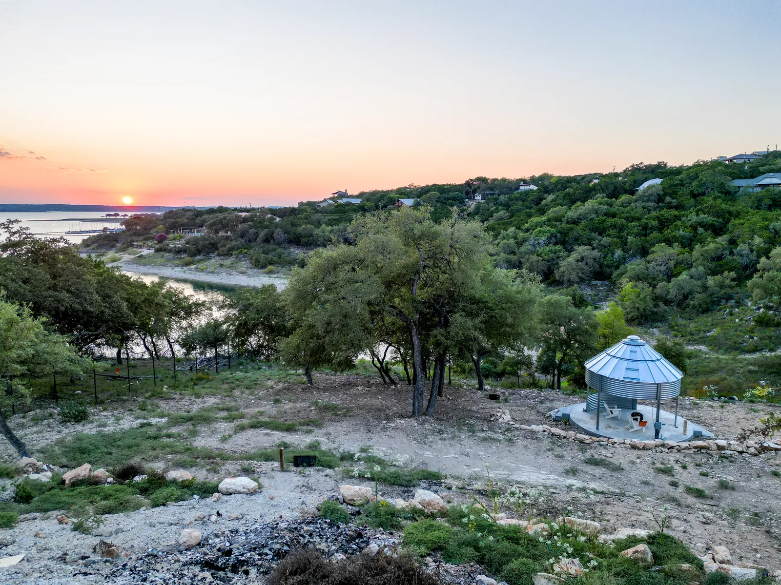 Sunset over Canyon Lake with a metal gazebo on the grounds of The Container Retreat