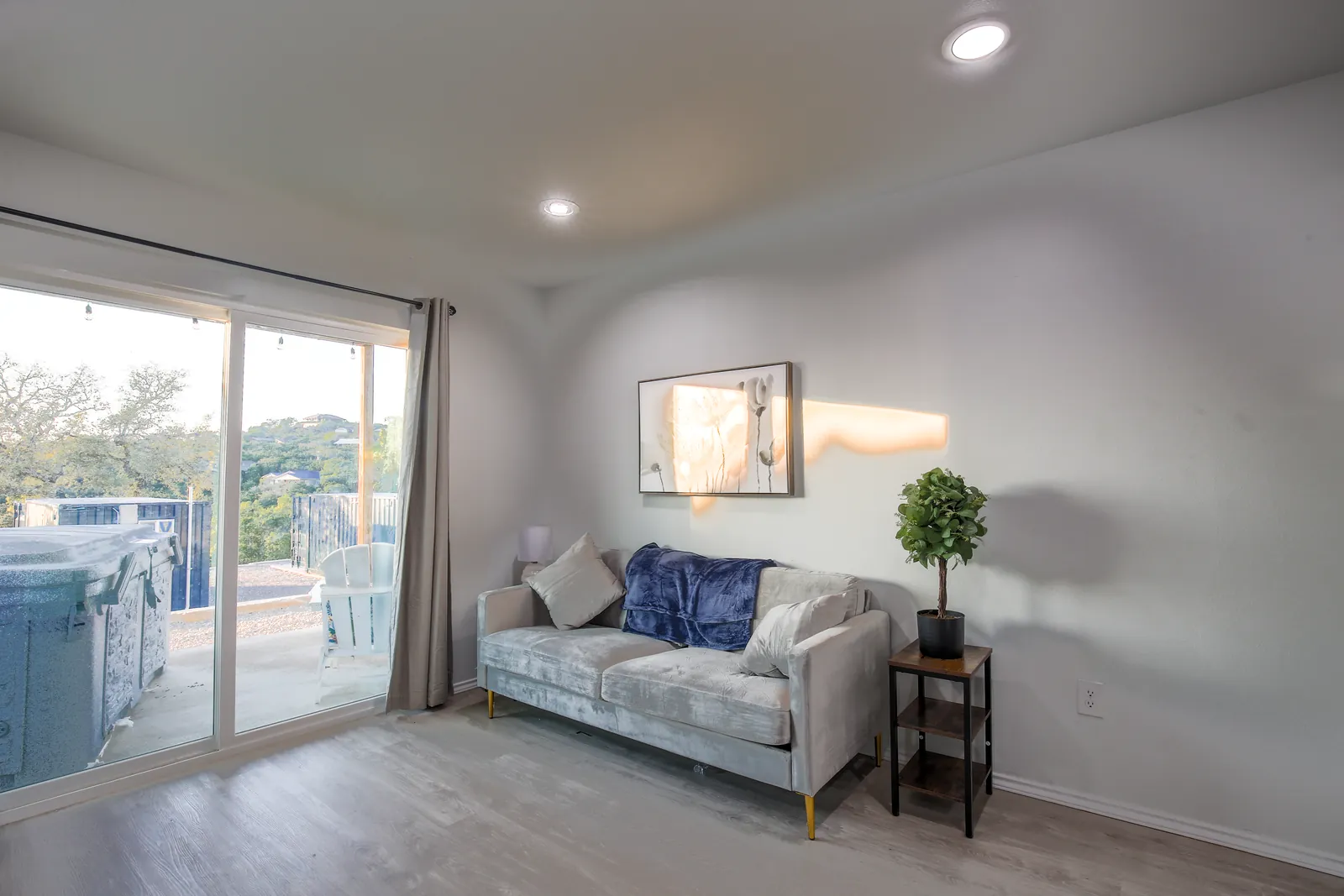 Furnished living room with a sofa and sliding door to a private deck at The Container Retreat